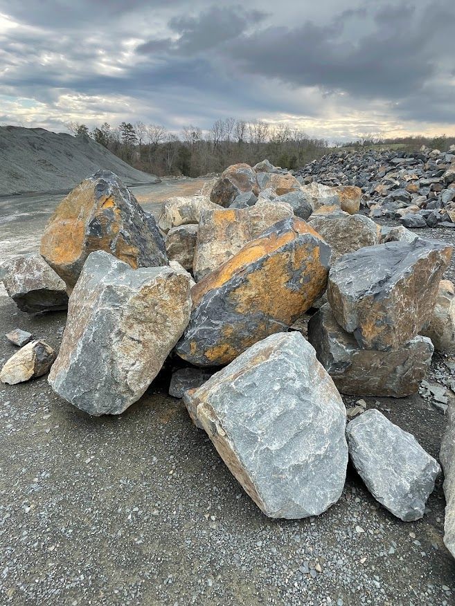 a pile of rocks sitting on top of a gravel road .