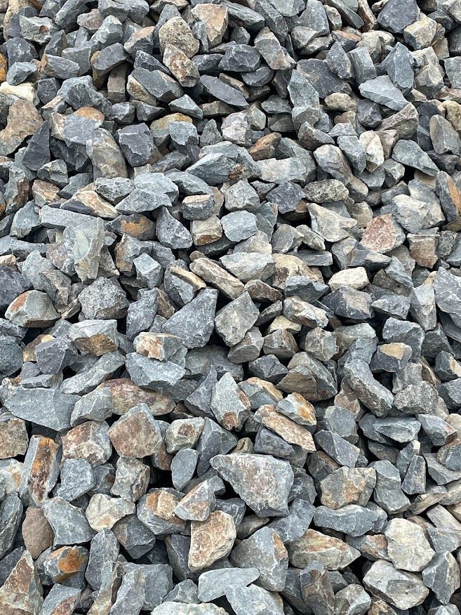 a pile of rocks that are gray and brown ballast rock or stones