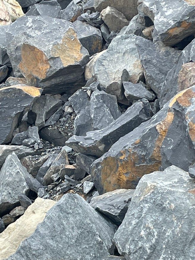 a pile of rocks that are gray and brown. Rip Rap rock materials