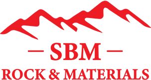 a logo for sbm rock and materials with a mountain in the background