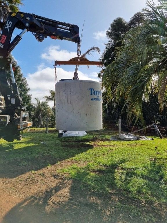 A Septic Tank is Sitting in the Dirt Next to a Concrete Barrel — TCP Plumbing in Tunglebung, NSW