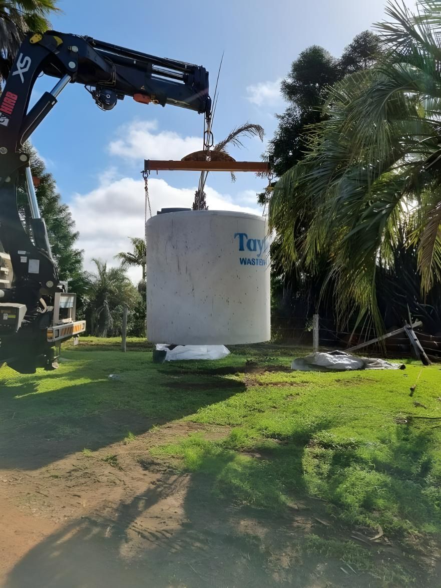 A Large Concrete Cylinder is Being Lifted by a Crane — TCP Plumbing in Bonalbo, NSW