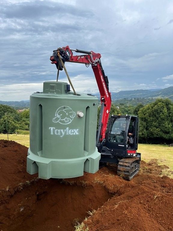 A crane truck lifts and positions a large concrete wastewater tank — TCP Plumbing in Tenterfield, NSW