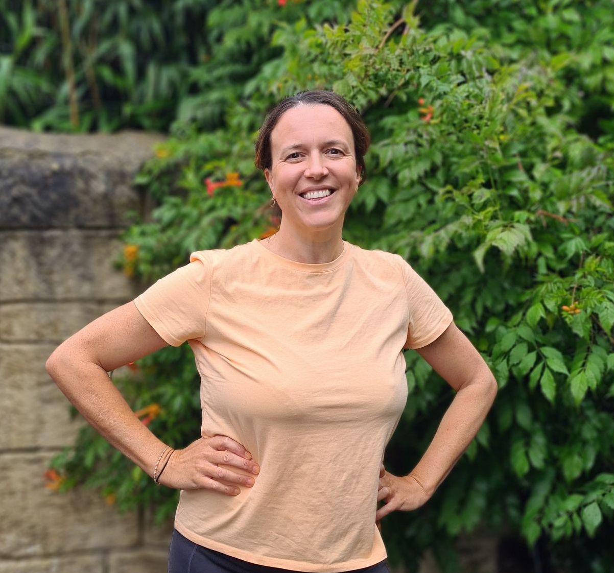 A portrait picture of caroline mac, marketing specialist, standing at a scenic view on the isle of wight