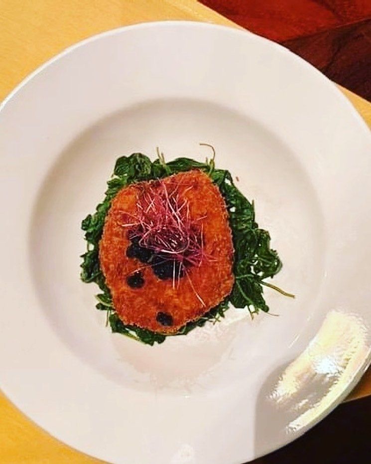 A white plate with a piece of food on it