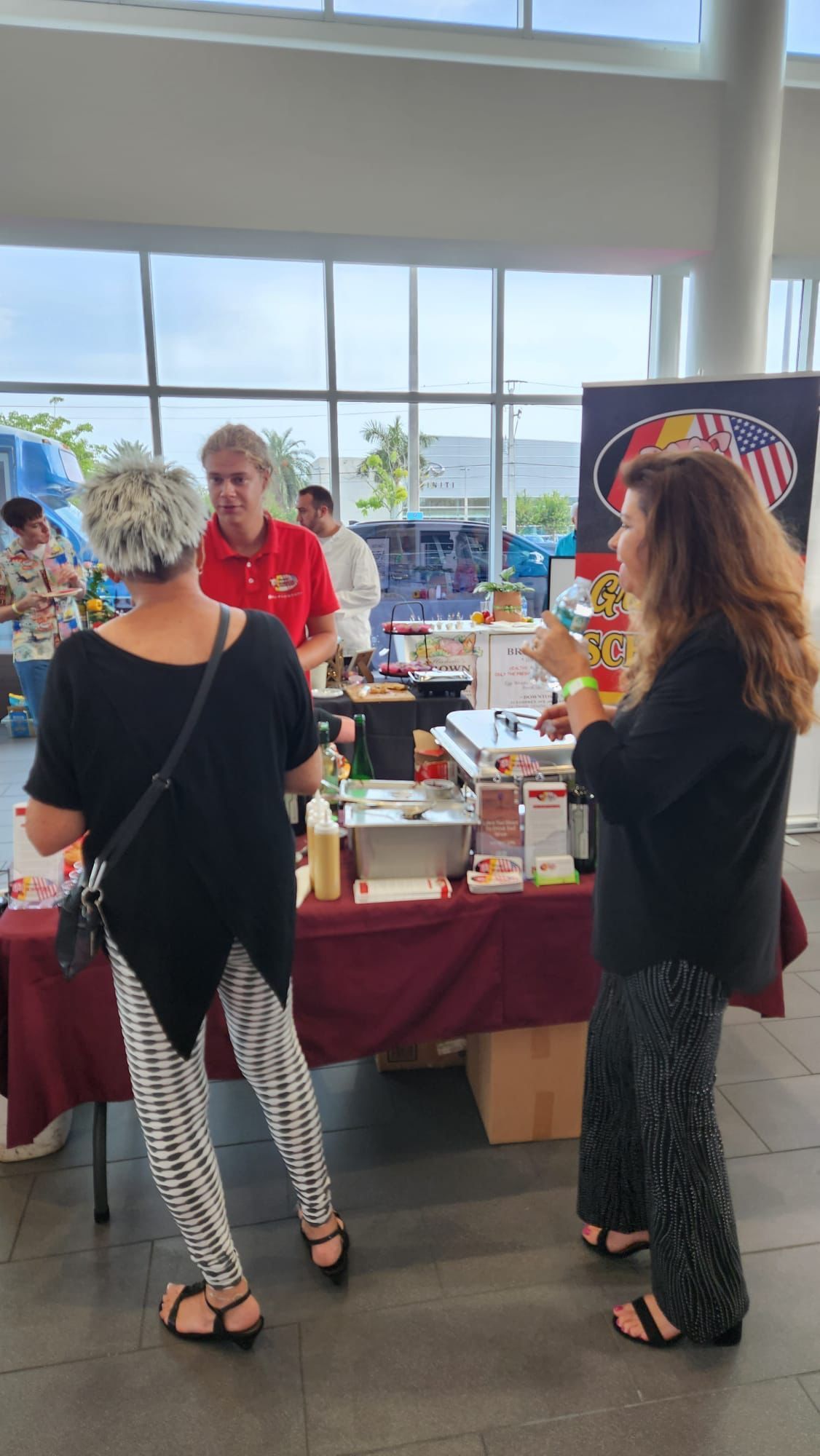 A group of people are standing around a table in a room.
