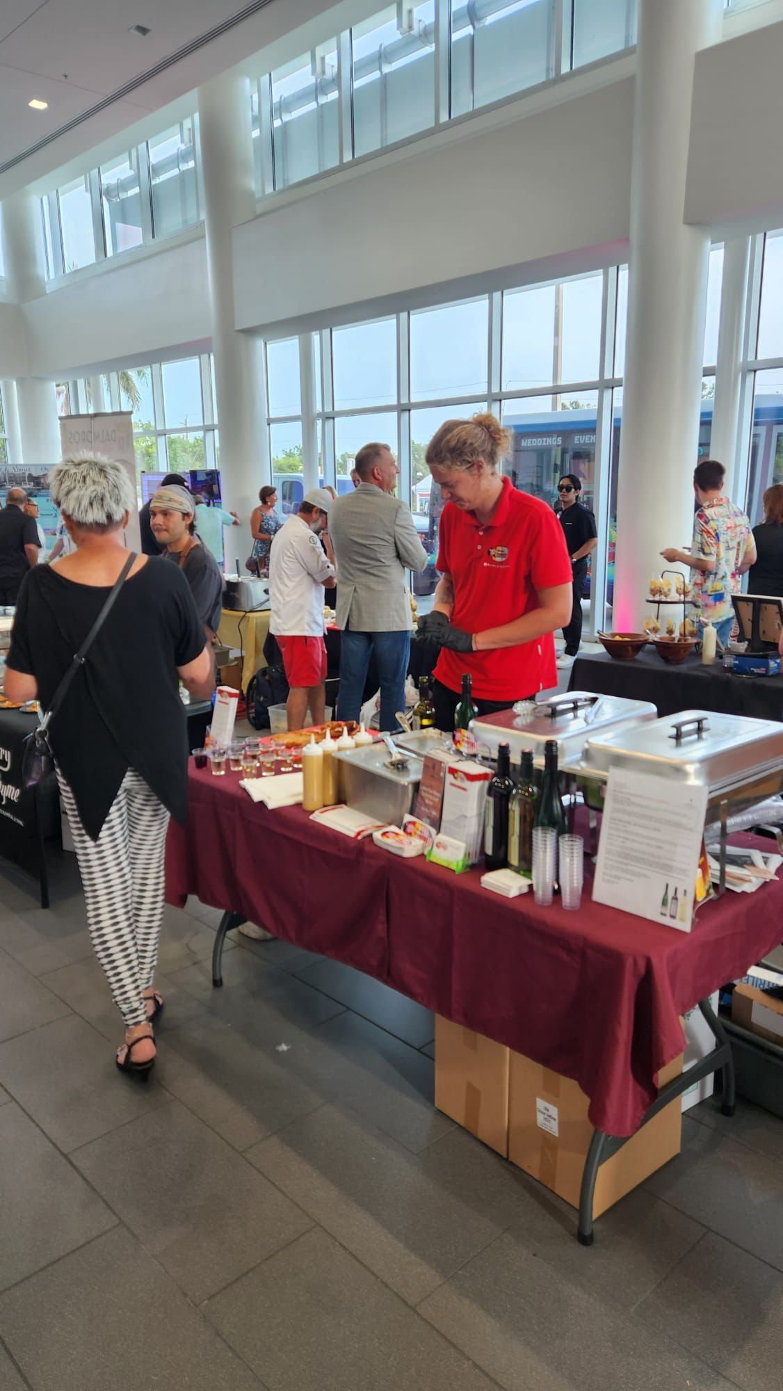 A group of people are standing around a table in a room.