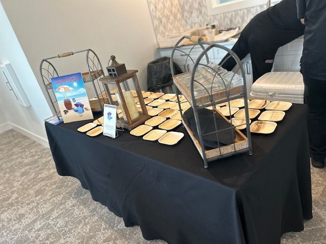 A table with a black tablecloth and plates on it.