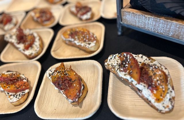 A bunch of plates of food are sitting on a table.