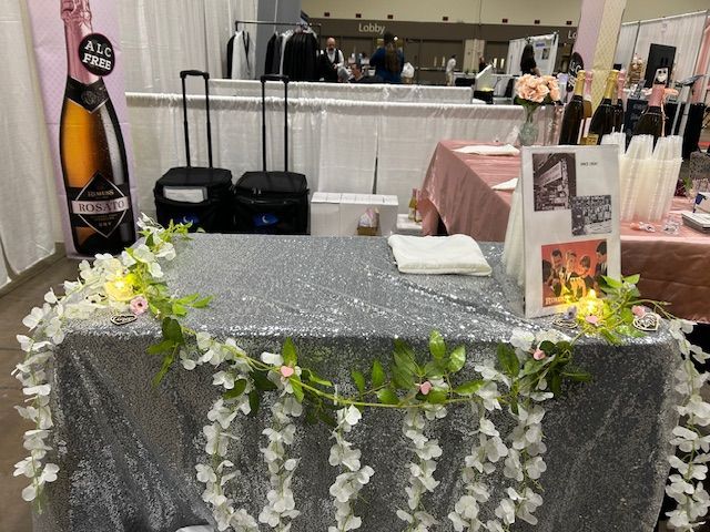 A table with flowers and a bottle of champagne on it.