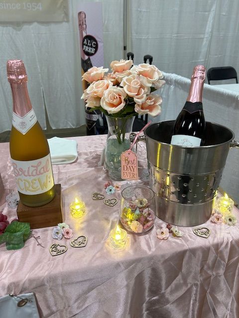 A table with bottles of champagne and flowers on it