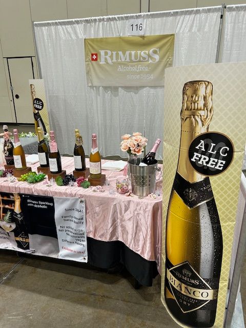 A table with bottles of wine and a sign that says alc free