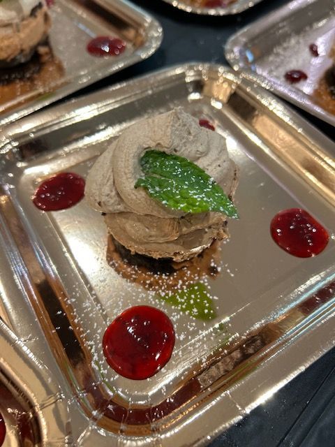 A close up of a dessert on a silver plate