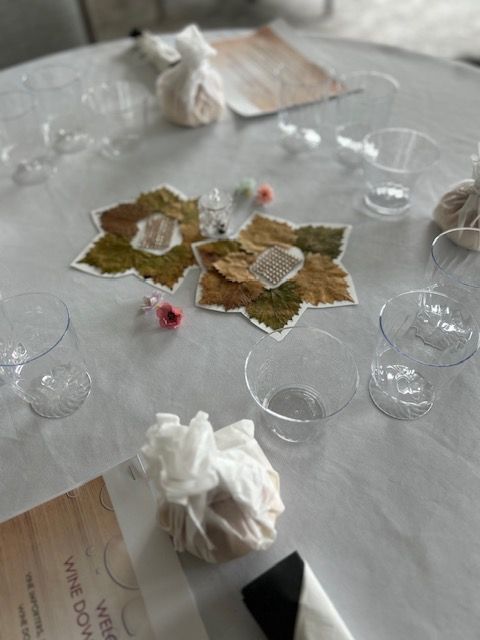 A table with wine glasses and leaves on it