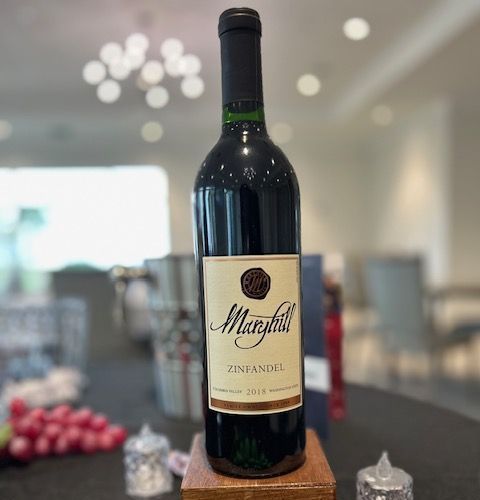 A bottle of zinfandel sits on a table