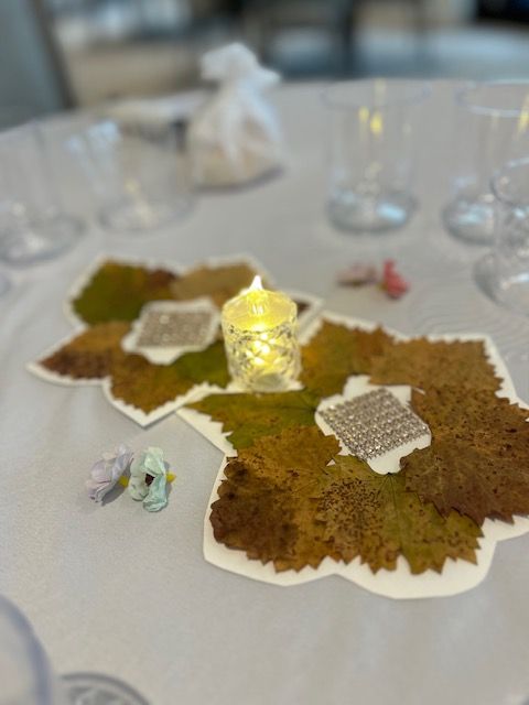 A table with leaves and a candle on it