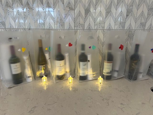 A row of wine bottles sitting on top of a counter.