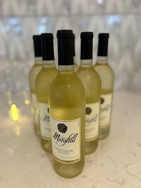 Several bottles of marshall wine are lined up on a table