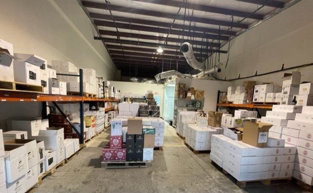 A large warehouse filled with lots of boxes and shelves