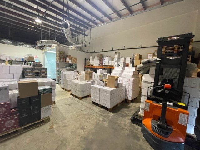 A warehouse filled with lots of boxes and a forklift.