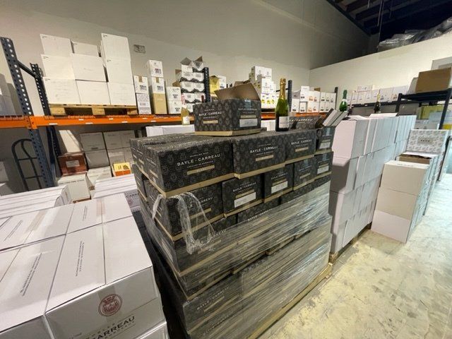 A warehouse filled with lots of boxes and bottles of wine.