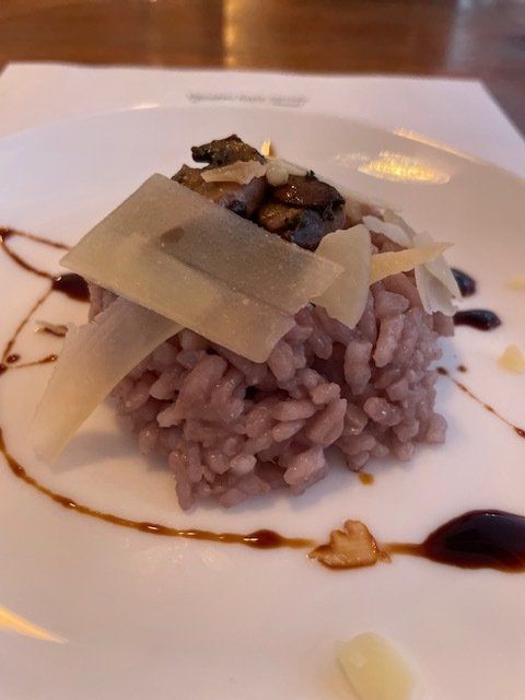 A close up of a plate of food with rice and cheese