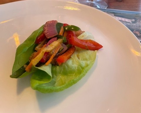 A close up of a salad on a white plate