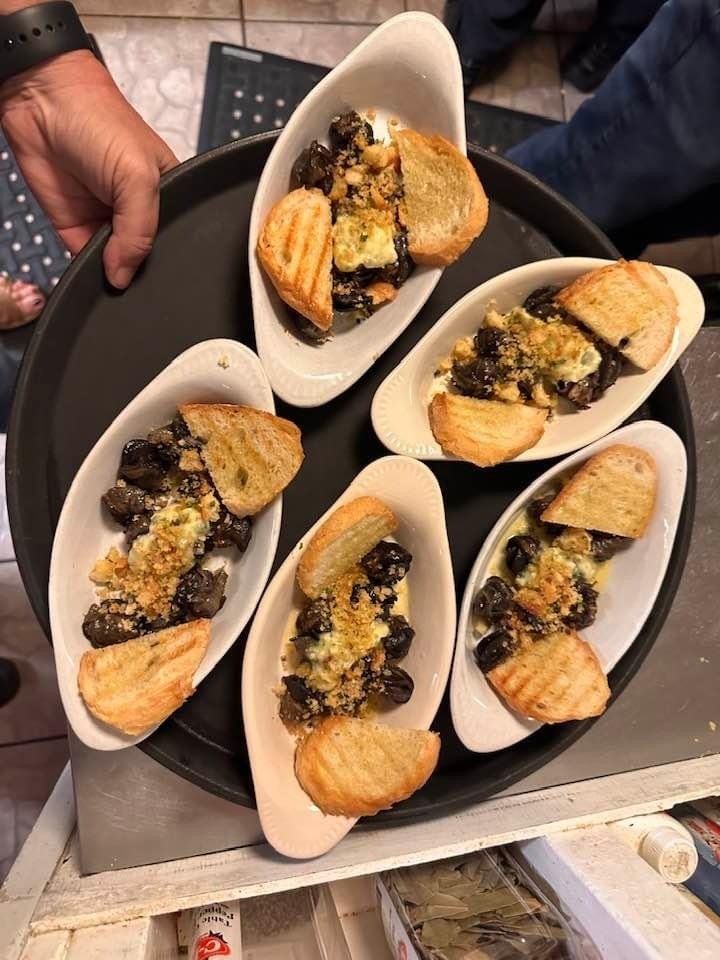 A person is holding a tray of food on a table