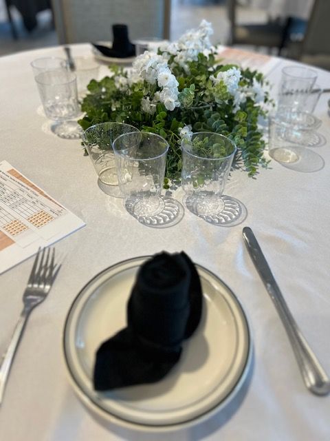 A plate with a napkin on it sits on a table