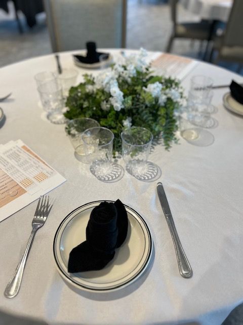 A plate with a napkin on it sits on a table