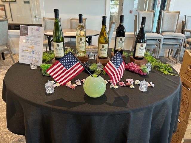 A table with bottles of wine and american flags on it