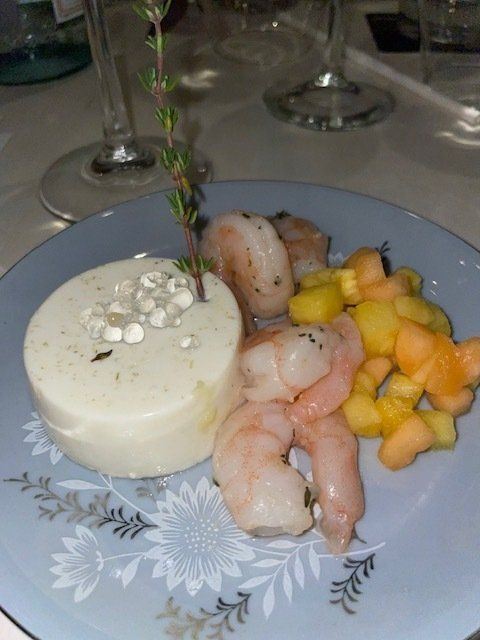 A plate of food with shrimp and melon on it