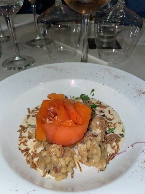 A close up of a plate of food with a rose on top