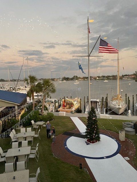 A christmas tree is in the middle of a white carpet