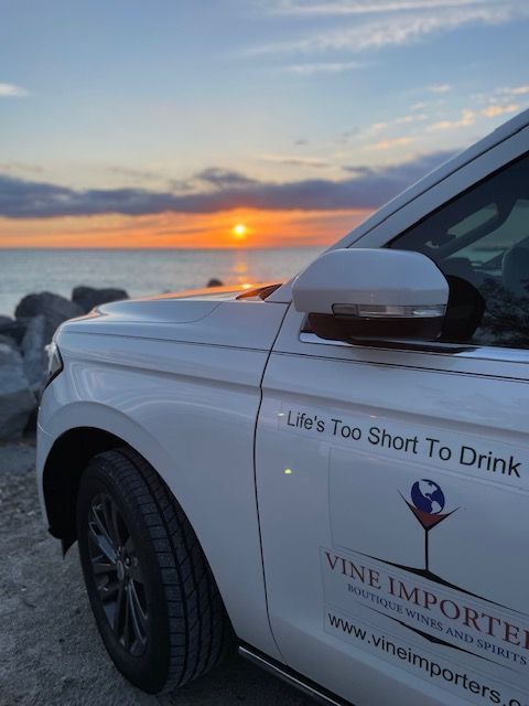A white car with vine imported written on the side