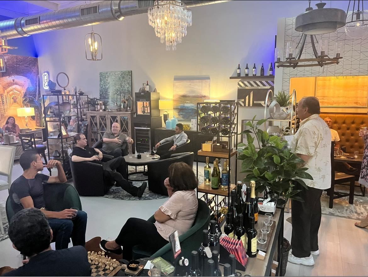 A group of people are sitting in a room with a man standing in front of them.