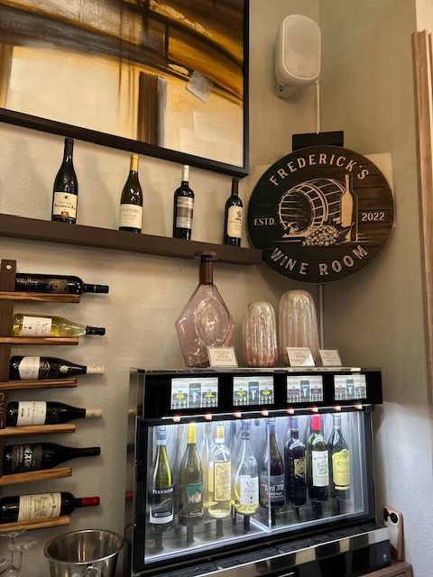 Bottles of wine are displayed in a frederick 's wine room