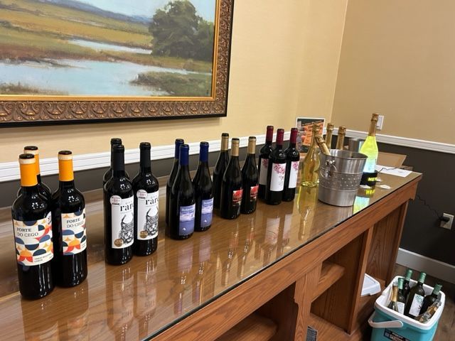 Several bottles of wine are lined up on a table