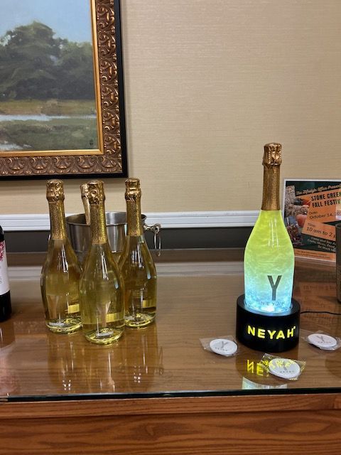 A table with bottles of champagne and a bottle of neyah on it