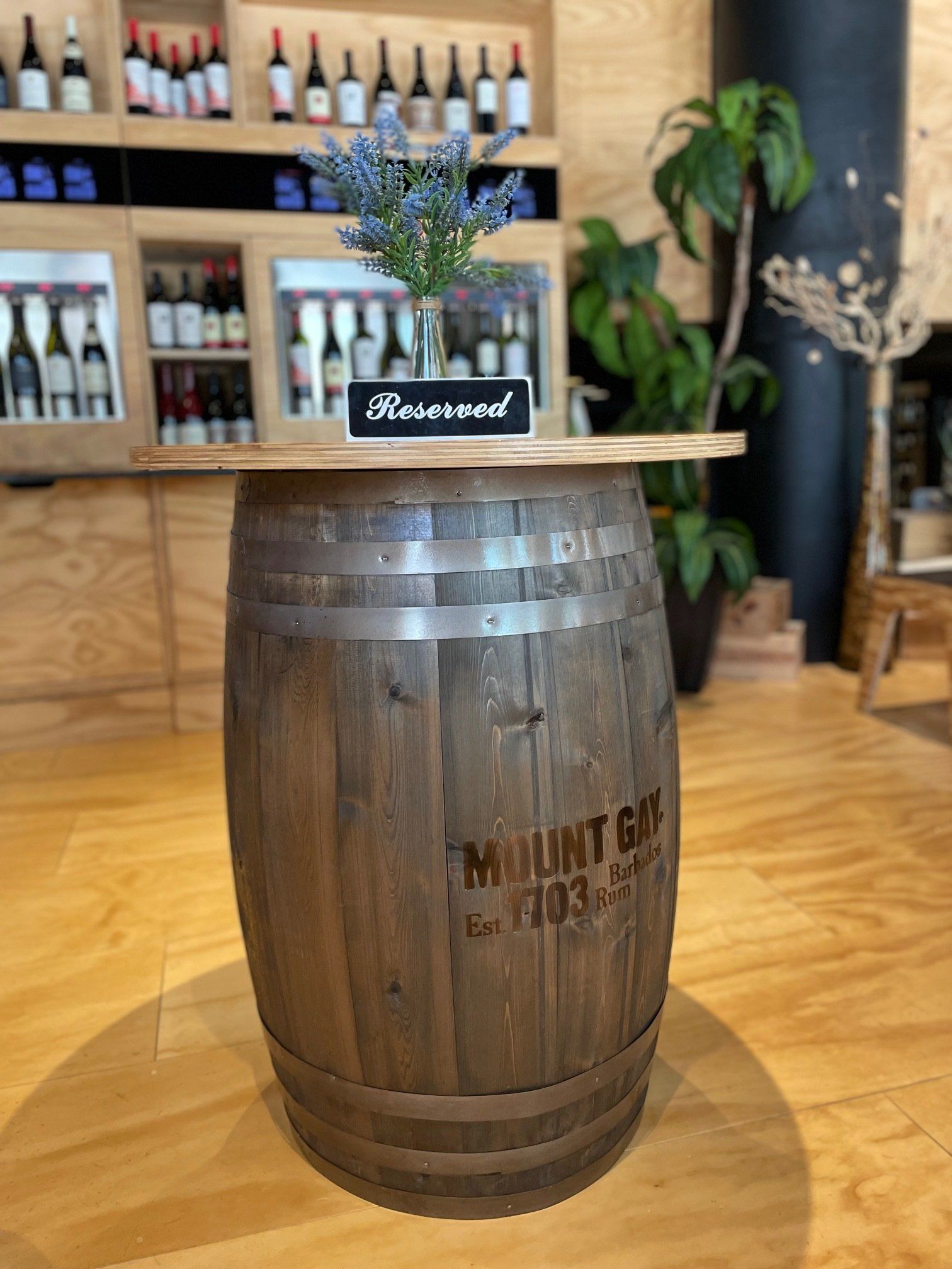 A wooden barrel is sitting on a wooden floor in a room.