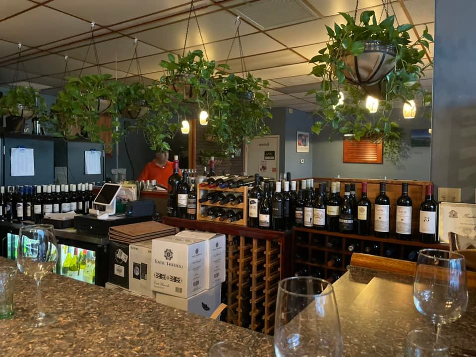 A bar filled with lots of wine bottles and glasses