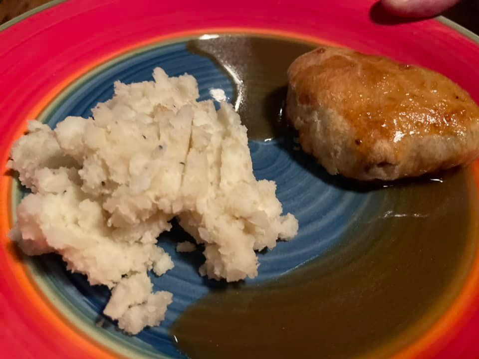 A plate of food with mashed potatoes and gravy on it