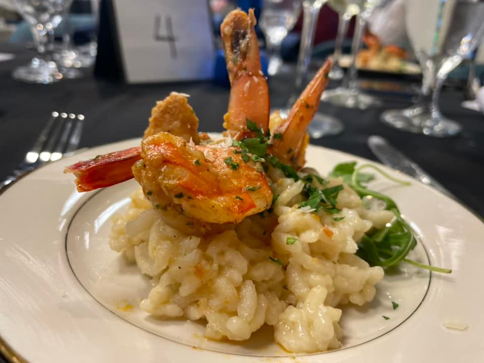 A plate of food with shrimp and rice on a table.
