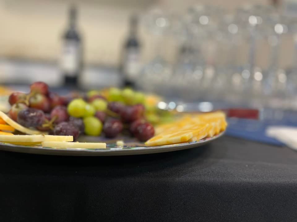 A plate of grapes , cheese , and crackers on a table.