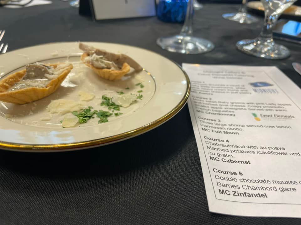 A plate of food is on a table next to a menu.