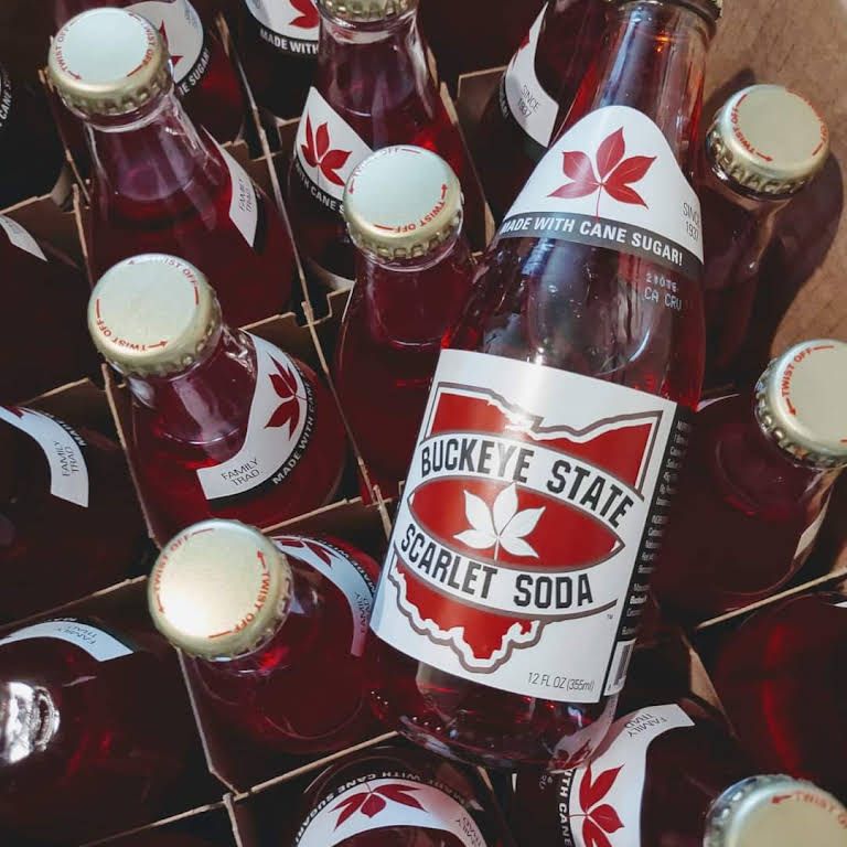 Bottles of buckeye state scarlet soda are stacked on top of each other