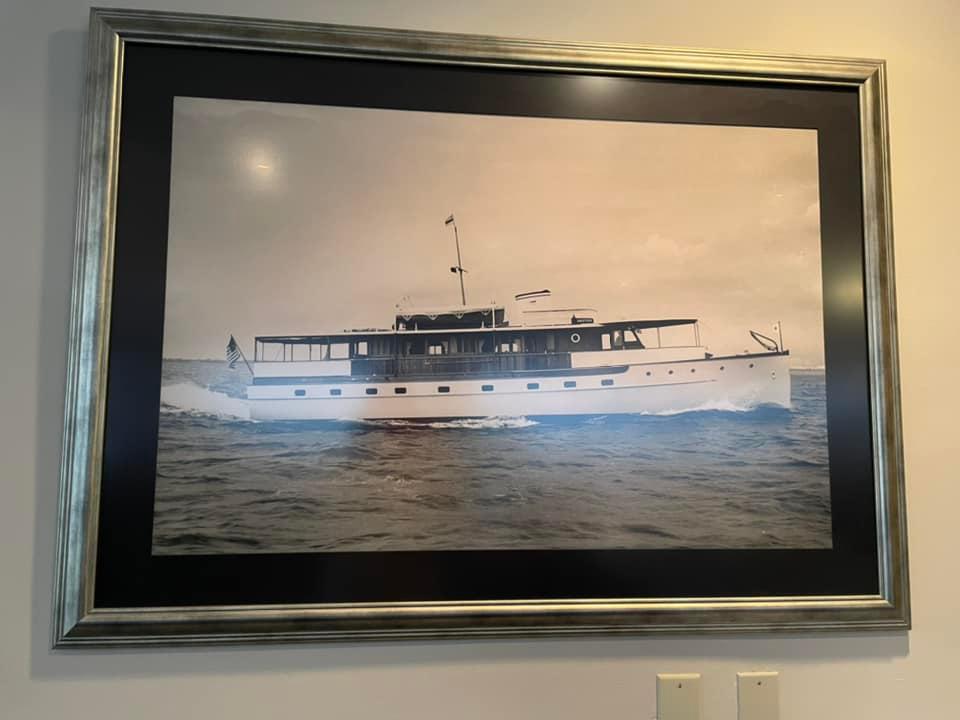 A framed picture of a boat in the ocean