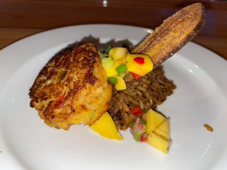 A close up of a plate of food with rice and vegetables