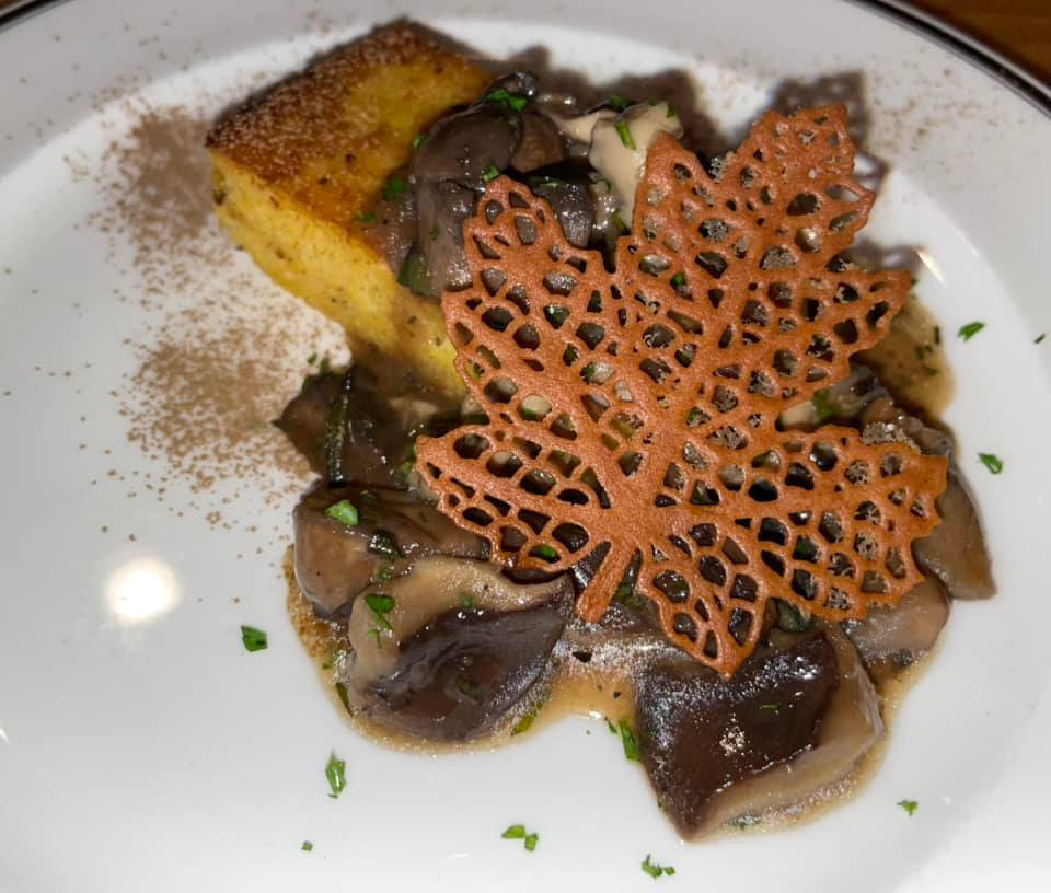 A close up of a plate of food with a maple leaf on top