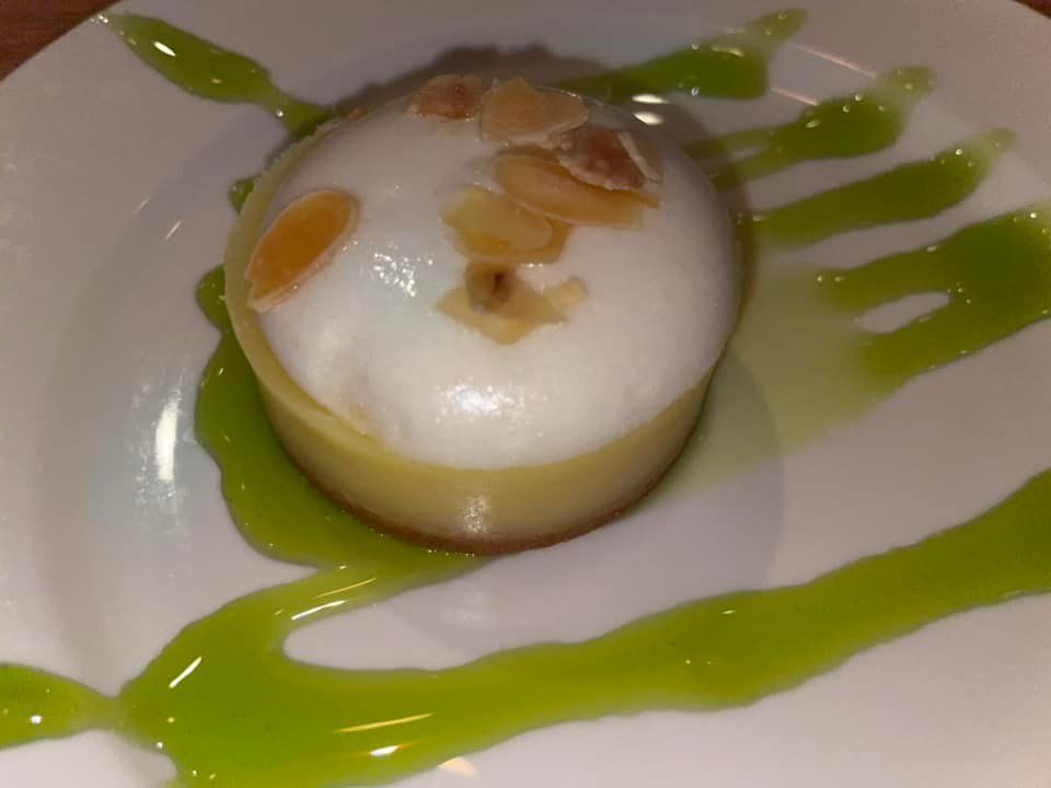A dessert on a white plate with green sauce